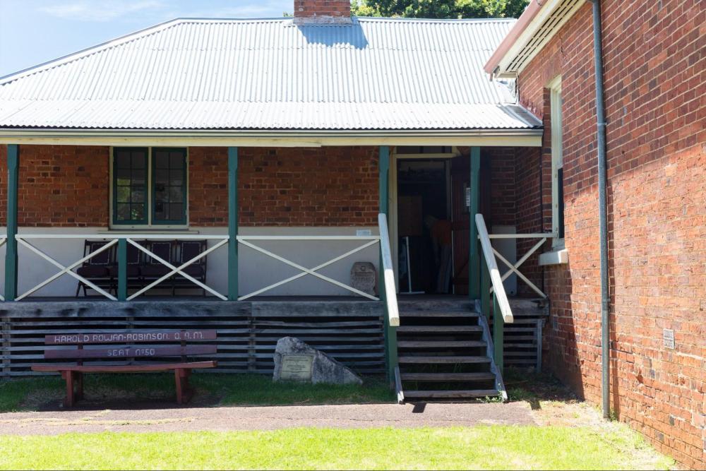 A brick building with a tin roof