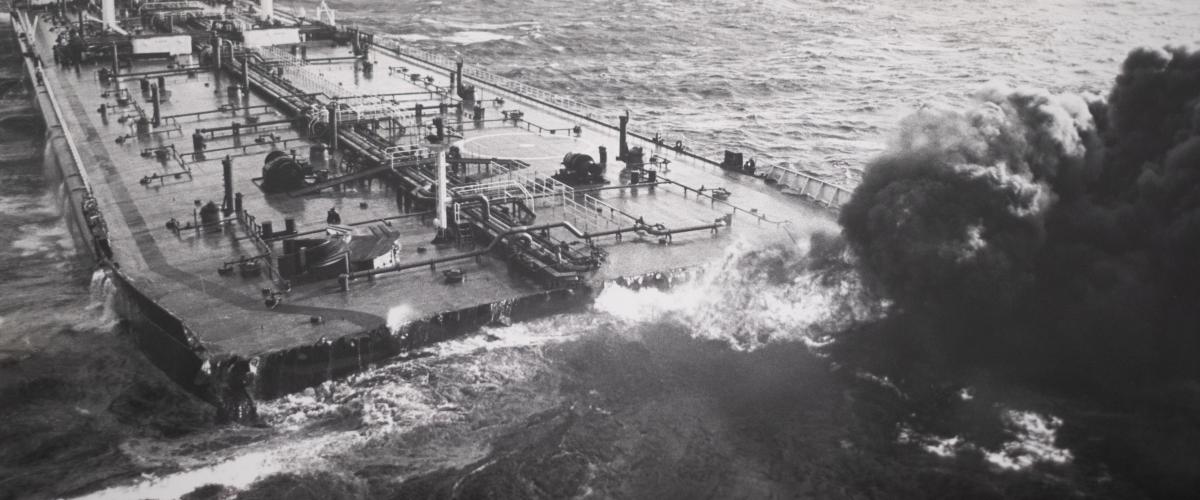 Large upper deck of a shipwreck protruding from the ocean.