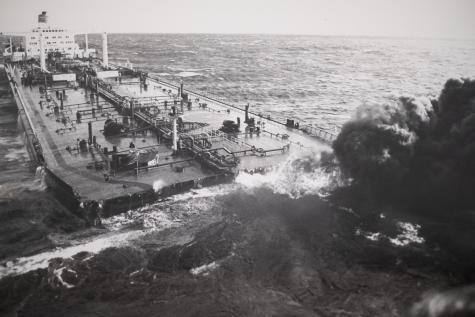 Large upper deck of a shipwreck protruding from the ocean.